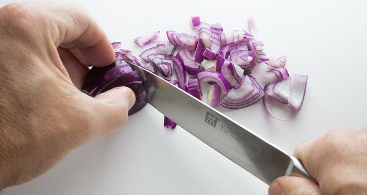 How do you cut onions with a Chef's Knife?