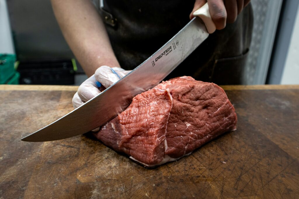 butchers knife slicing meat