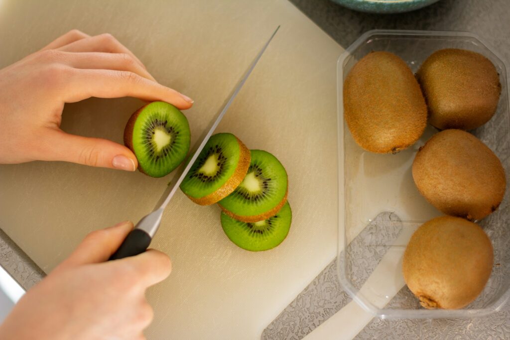 knife cutting kiwi fruit