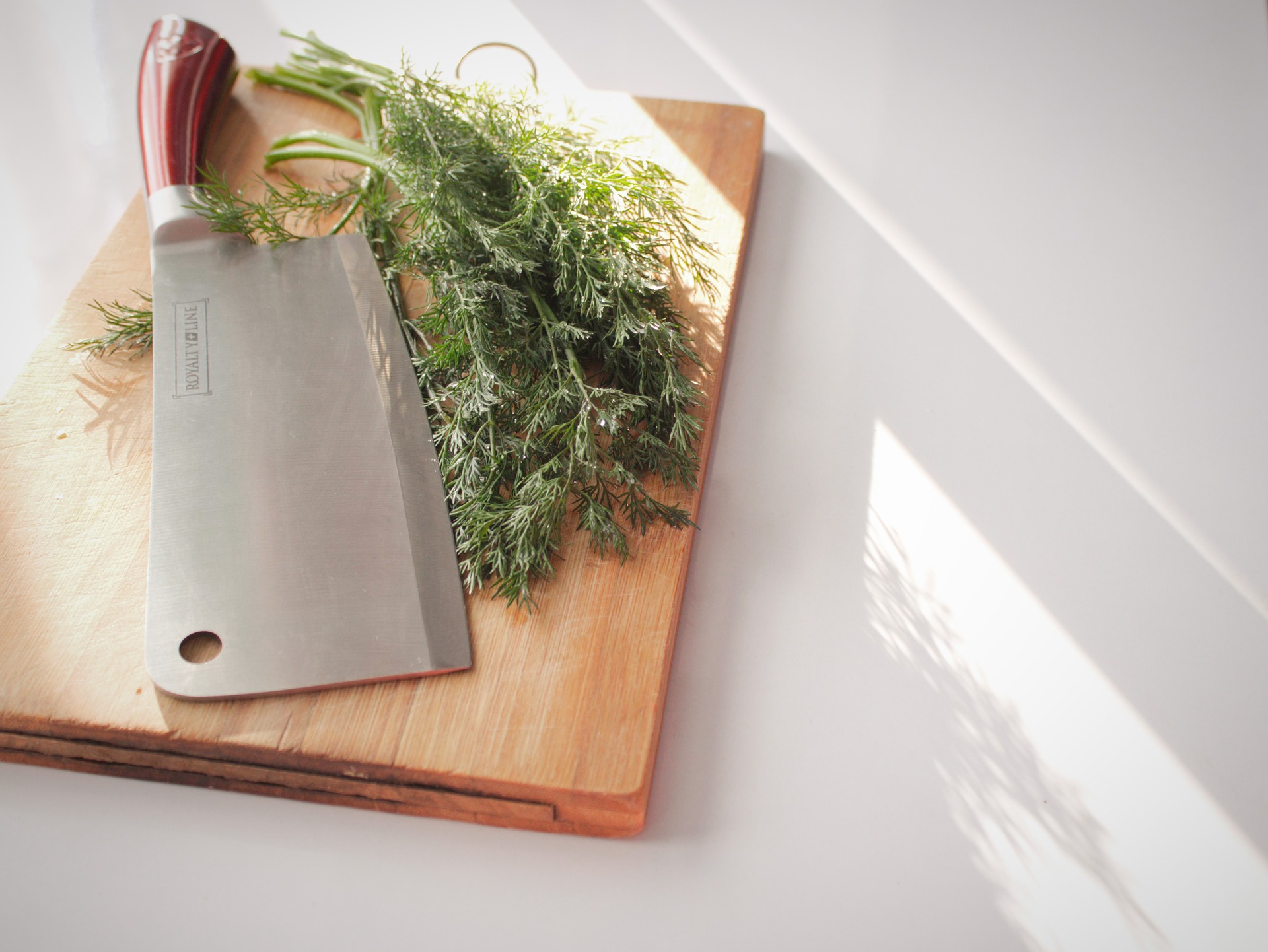 vegetable cleaver and wooden chopping board